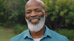 portrait old african american man smiling looking happy in park enjoying