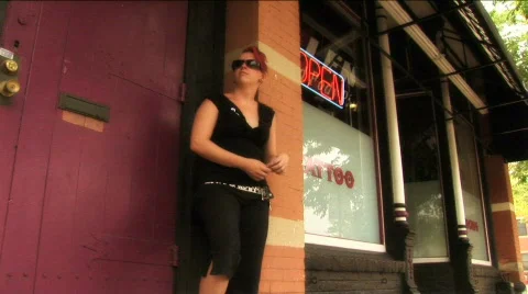 (1112) Tattooed young woman with Mohawk in front of Tattoo Parlor Stock Footage