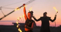 A group of professional circus performers with fire shows dance shows in slow