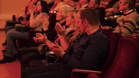 11.25.2022 - Gomel, Belarus: Audience clapping hands in dark theater hall Stock Footage 335522556