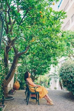 Woman in yellow dress in lemon garden of Sorrento at summer xkwx sorrento, lemon, woman, vacation, garden, relax, italian, enjoy, smell, amalfi, farm, italy, agriculture, amalfitana, branch, bright, bunch, citrus, closeup, crop, cultivated, culture, foliage, food, fresh, freshness, fruit, gardening, green, growing, growth, hanging, harvest, healthy, horticulture, juicy, leaf, lemons, mediterranean, nature, orchard, organic, plant, ripe, tranquil, tree, trees, vitamin, yellow