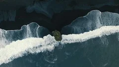 Cinematic aerial view of waves breaking dramatically on the icelandic coast