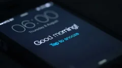 Good morning alarm clock on the phone in the dark room, detailed view