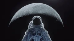 Dolly shot of an astronaut in spacesuit with moon in the background.