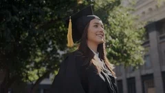Graduation day in high school or university. Attractive female student in
