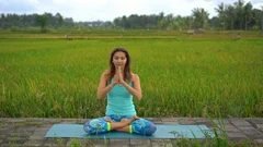 Slowmotion steadicam shot of a young woman doing meditation for Muladhara chakra
