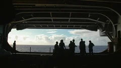 Group of Navy officers standing inside the USS Carl Vinson