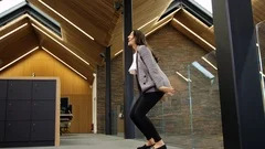 Bullet time, an attractive young businesswoman jumping up and down in the office