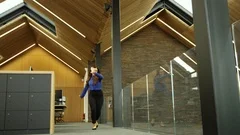 Happy businesswoman doing a cartwheel in the office, shot in bullet time action 