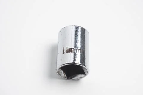 A 11mm socket made of chrome-plated steel, showing signs of wear and rust. .. Stock Photos