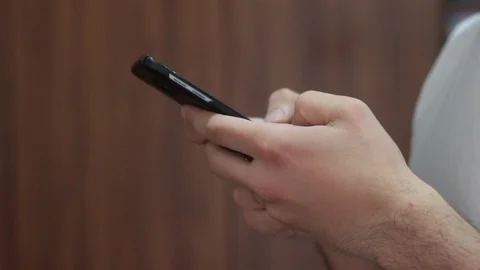 11Young man using smartphone while doing homework. Stock Footage 127531229