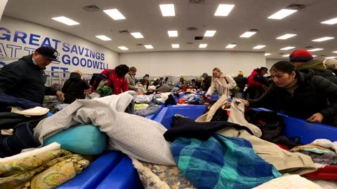 12-30-2025: Hackensack, NJ, USA: Rummaging at the Goodwill bins Stock Footage 325348385