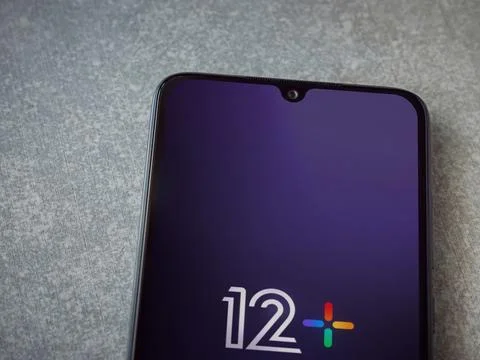 12+ app launch screen on smartphone on ceramic stone background Stock Photos