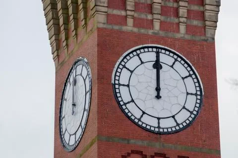 12 oclock on the face of a large brick clock tower at the university of Birmi Stock Photos