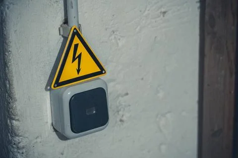 12 October 2022: A light switch on a power line with a warning sign, power... Fotos Stock