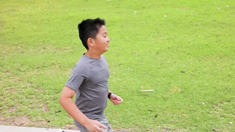 12 Year Old Boy Jogging In a Park in Los Angeles 動画素材 284737034