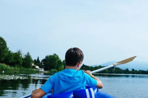 12 year old boy lying in canoe on Lake Monate Stock Photos