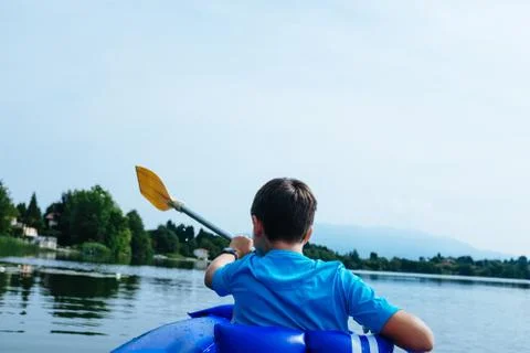 12 year old boy lying in canoe on Lake Monate Stock Photos