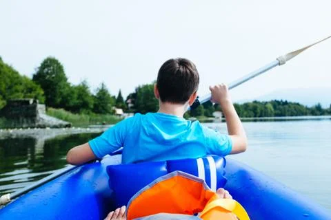12 year old boy lying in canoe on Lake Monate Stock Photos