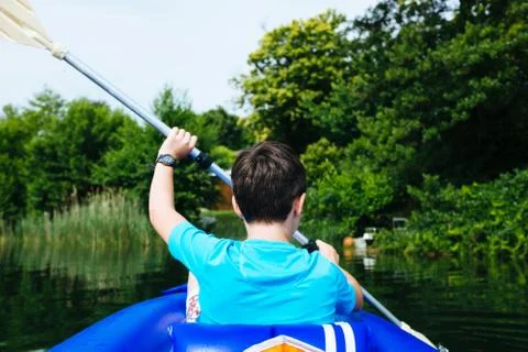 12 year old boy lying in canoe on Lake Monate Stock Photos