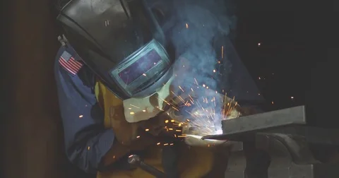 120 fps slow motion shot of a female worker using a welder at a metal shop. Stock Footage 72987519
