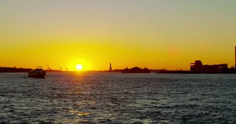 120 fps slow motion shot of a sunset with the Statue of Liberty in the Stock Footage 73332884