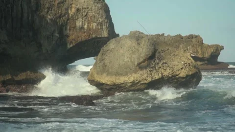 120 fps slow-motion shot of ocean waves crashing on sea rocks in Madasari. Stock Footage 312839194