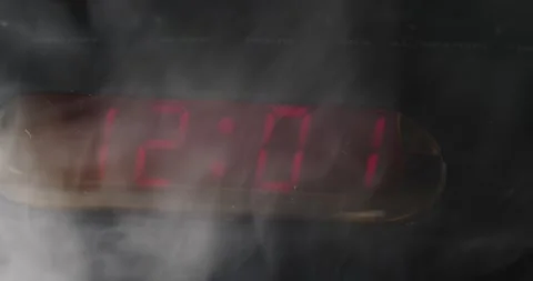 12:00 a.m. change to 12:01 a.m. digital clock smoke swirling slow motion Stock Footage 204060889