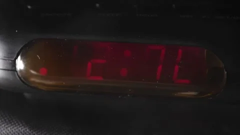 12:00 a.m. digital clock blinking red numbers slow motion Stock Footage 204060997