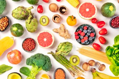 Vegan  food.  Healthy  diet  concept.  Fruits,  vegetables,  pasta,  nuts,  legumes,  mushrooms,  shot  from  the  top  on  a  white  background.  A  flat  lay  composition xkwx vegan,  vegetarian,  food,  healthy,  diet,  white,  background,  fruit,  vegetable,  pasta,  mushrooms,  legumes,  pulses,  overhead,  above,  view,  top,  shot,  flat,  lay,  flat  lay,  flatlay,  nuts,  table,  cooking,  kitchen,  raw,  fresh,  nutrition,  ingredient,  concept,  veg,  produce,  supermarket,  organic,  vitamin,  protein,  carbohydrate,  fiber,  wholesome,  natural,  superfood,  grapefruit,  artichoke,  broccoli,  various,  variety,  assortment,  many,  different