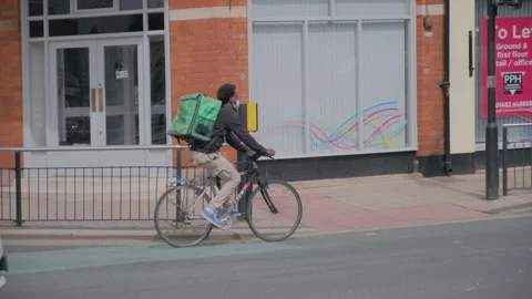 120fps. Uber Eats. Food delivery service, man on bike. Hull.06.05.2024 Stock Footage 274932820