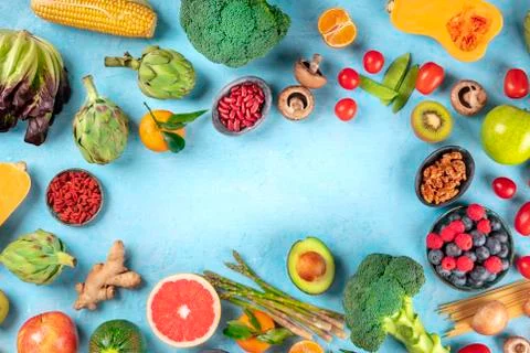 Vegan  food.  Healthy  diet  concept.  Fruits,  vegetables,  pasta,  nuts,  legumes,  mushrooms,  shot  from  above  on  a  blue  background,  forming  a  frame  with  a  place  for  text.  A  flat  lay  composition xkwx vegan,  vegetarian,  food,  healthy,  diet,  background,  fruit,  vegetable,  pasta,  mushrooms,  legumes,  pulses,  overhead,  above,  view,  top,  shot,  flat,  lay,  flat  lay,  flatlay,  nuts,  table,  kitchen,  raw,  fresh,  nutrition,  ingredient,  veg,  produce,  organic,  vitamin,  fiber,  wholesome,  grapefruit,  artichoke,  broccoli,  variety,  many,  frame,  copy,  space,  copyspace,  copy  space,  place,  text,  ginger,  design,  template,  menu