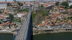 Aerial push in over metro train on Luís I bridge in city of Porto, Portugal