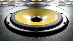Close-up of audio speaker with yellow membrane playing rhythmic music loop