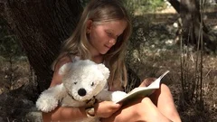 Child Reading Book by Tree Schoolgirl Enjoying Outdoor Kid Studying in Nature 4K