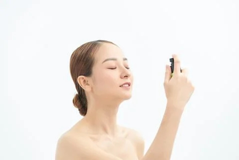 Beautiful Asian woman applying spray water on face on neutral background. xkwx spaying, care, fresh, healthy, face, water, portrait, health, spray, thermal, white, beautiful, freshness, bottle, skin, young, beauty, woman, background, applying, treatment, person, closeup, girl, spa, natural, product, model, asian, vietnamese, korean, japanese, chinese