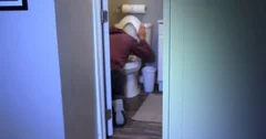 Defocused Shot of Man Vomiting in Toilet