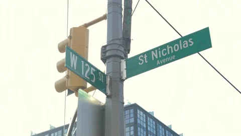 125 and St Nick intersection sign in Harlem people walking street New York City 스톡 동영상 169934285