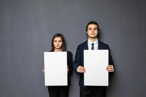 Confident business couple standing with blank board to advertise or invite on gray background xkwx background, woman, business, hand, love, person, girl, couple, man, school, banner, paper, young, isolated, space, happy, blank, showing, board, female, male, casual, studio, smile, presentation, white, billboard, guy, job, feeling, portrait, work, copy, together, posing, surprised, product, caucasian, camera, boyfriend, relationship, romantic, expression, presenting, adult, gesture, two, people, message, invitation
