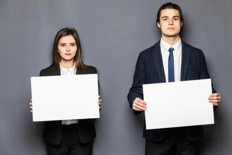 Confident business couple standing with blank board to advertise or invite on gray background xkwx background, woman, business, hand, love, person, girl, couple, man, school, banner, paper, young, isolated, space, happy, blank, showing, board, female, male, casual, studio, smile, presentation, white, billboard, guy, job, feeling, portrait, work, copy, together, posing, surprised, product, caucasian, camera, boyfriend, relationship, romantic, expression, presenting, adult, gesture, two, people, message, invitation