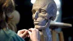 Sculptor at work. Woman working at the human head.