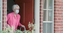 An old lady with a walker receives food delivery during coronavirus outbreak