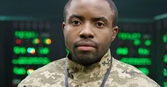 Close up of young African American militarian male officer looking at camera wih