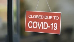 Red closed sign due to Covid-19 on shop window