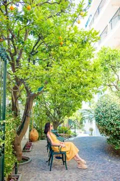 Woman in yellow dress in lemon garden of Sorrento at summer in Italy xkwx sorrento, lemon, woman, vacation, garden, relax, italian, enjoy, smell, amalfi, farm, italy, agriculture, amalfitana, branch, bright, bunch, citrus, closeup, crop, cultivated, culture, foliage, food, fresh, freshness, fruit, gardening, green, growing, growth, hanging, harvest, healthy, horticulture, juicy, leaf, lemons, mediterranean, nature, orchard, organic, plant, ripe, tranquil, tree, trees, vitamin, yellow