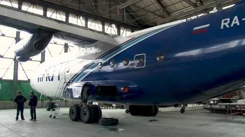 An-12BK planes are being repaired in hangar. An-12BK of Irkut airline RA-11310. Video stock 194495995