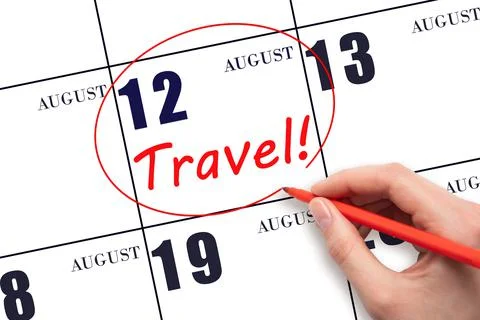12th day of August. Hand drawing a red circle and writing the text TRAVEL on  Stock Photos