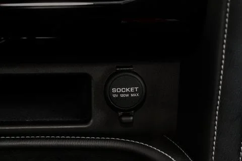 12V power outlet socket in the car. Closed socket in car. Stock Photos