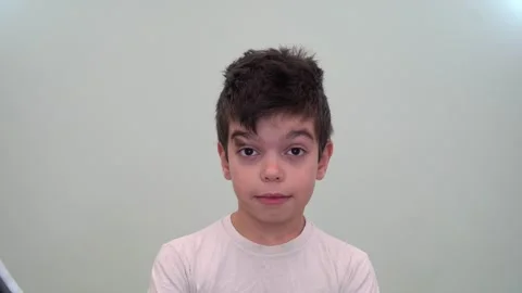 13 boy raises his eyebrows in surprise, brunette, brown eyes Stock Footage 268429674