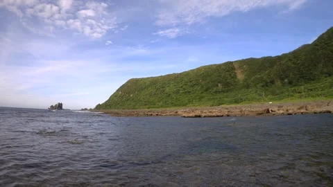 13021Slow motion horizontal pane view overlook out to coastline from the shallow Stock Footage 329642668